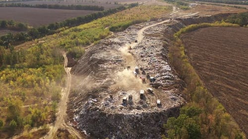 Aerial View of Large Garbage Pile at Sorting Site. Trucks Bring Waste To a Garbage Pile in Trash