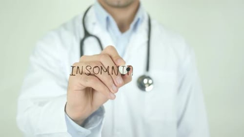 Doctor Writing Insomnia on Glass Surface