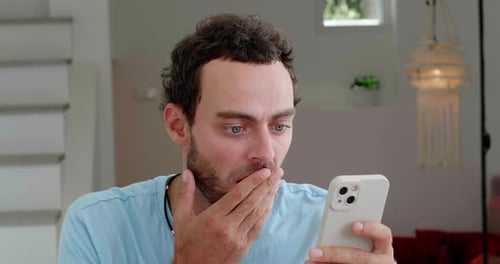 Man Reads Phone with Shifting Emotions