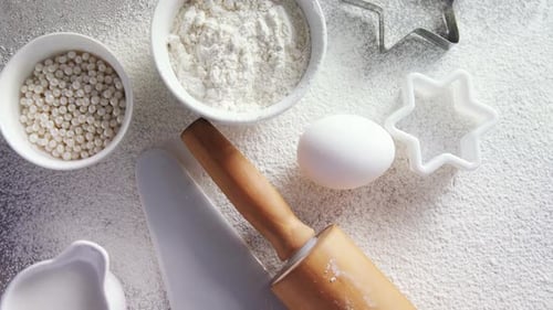 Baking Ingredients and Utensils on Flour-Dusted Surface