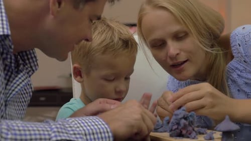 Family Working Together On Art Project Indoors