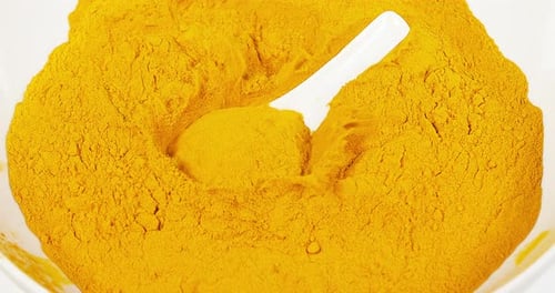 Turmeric, curcuma longa, Powder against White Background, Indian Spice, Slow Motion 4K