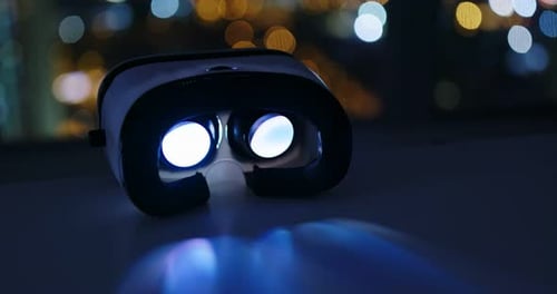 Virtual Reality Headset Glowing in Dark Room