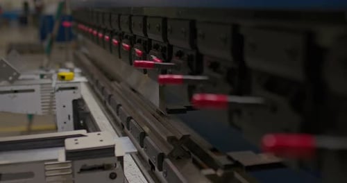 Worker in Gloves Makes a Bend on a Metal Part Using a CNC Closeup