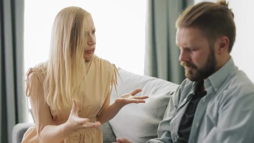 Upset Woman Arguing with Boyfriend on Couch