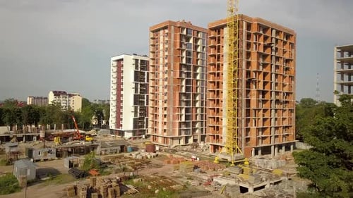 Aerial view of tall residential apartment buildings under construction. Real estate development.