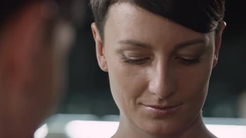 Woman Puts On Heart-Shaped Earrings in Mirror