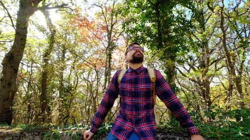 Portrait of Young Smiling Man Standing in Forest
