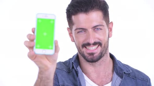 Smiling Man Showing Smartphone with Green Screen