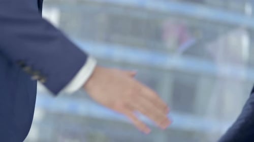 Close-up of Businessmen Shaking There Hands in Modern Office