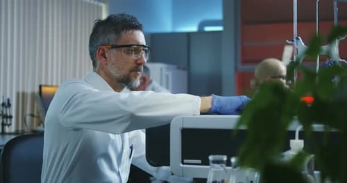 Scientists Working in a Brightly Lit Research Lab