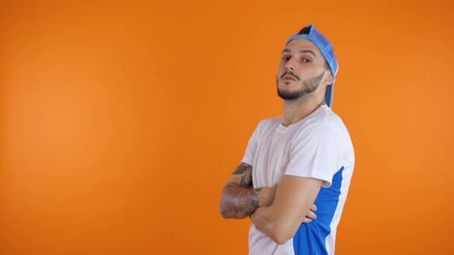 Man with Tattoos Standing with Arms Crossed