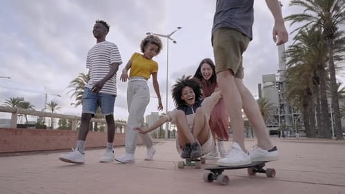 Group of Young People Having Fun Skateboarding in the City