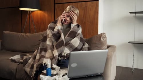 Woman Wrapped in Blanket Talks on Phone
