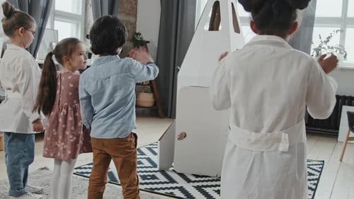 Children Playing with Rocket Ship Indoors