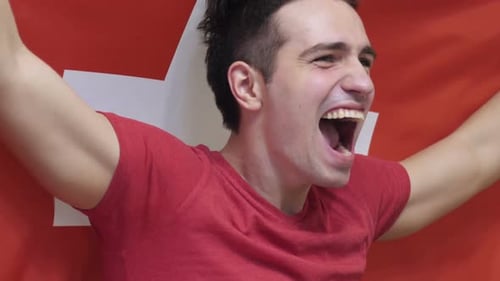 Excited Man Cheering with Red and White Flag