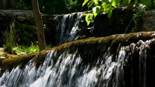 Peaceful Waterfall Cascading in Lush Green Environment