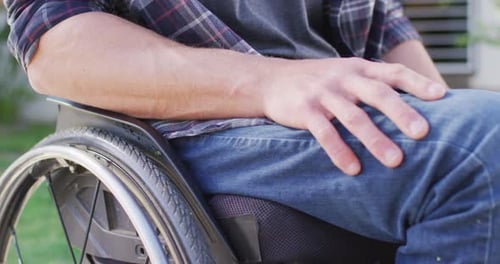 Close up of caucasian disabled man in wheelchair in street