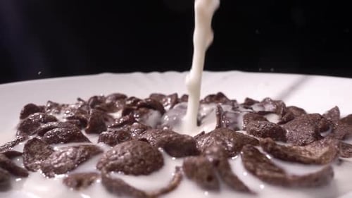 Milk Poured Into Bowl of Chocolate Cereal