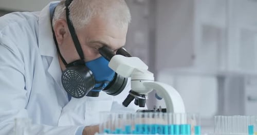 Scientist Works with Microscope in Laboratory Setting