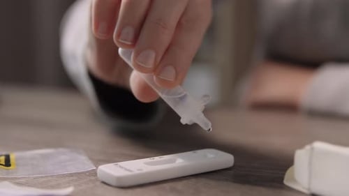 Dropping Liquid Sample onto Rapid Test Device