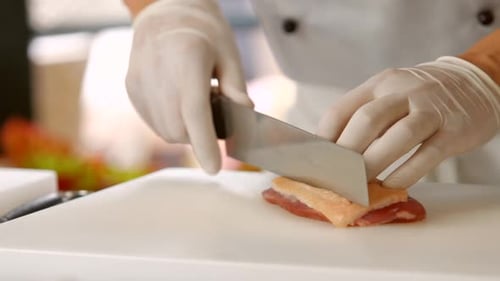 Chef Slicing Seared Duck Breast Meat in Kitchen