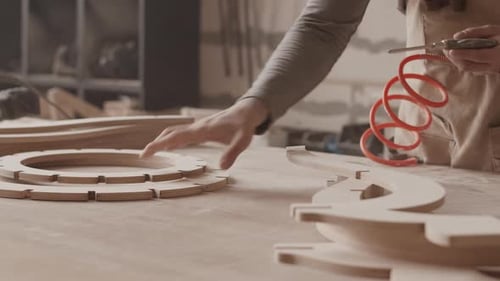 Man Working with Wood in a Woodworking Shop