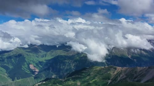 Stunning Mountain Range Aerial View with Cloudy Sky