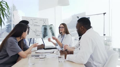 Medical Team Analyzing X-Ray in Bright Conference Room