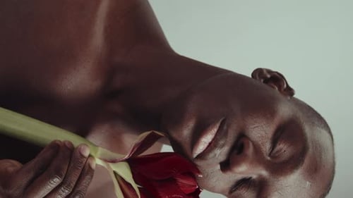 Handsome Man Holding a Red Flower