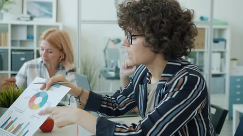 Multiracial Female Team Working Talking Discussing Business Information in Office
