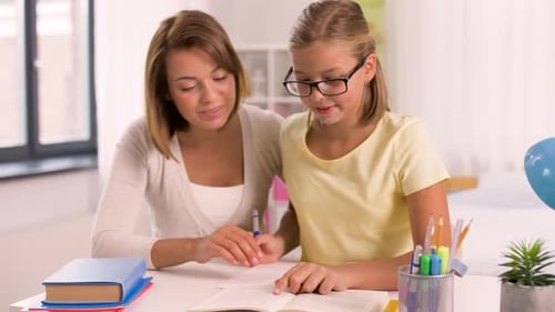 Girl Studying with an Adult at a Desk
