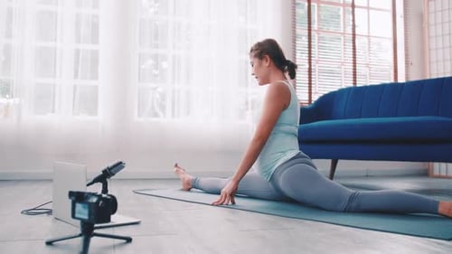 Pregnant Woman Performing Stretches at Home on Yoga Mat