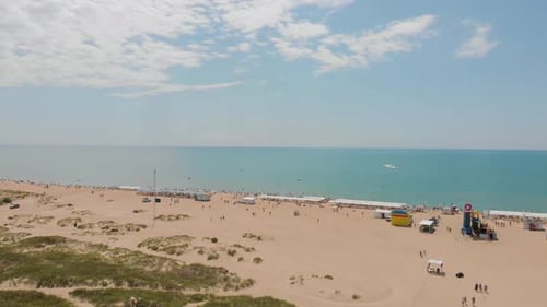 People Bathing in the Sun, Swimming on the Beach. Aerial View of Tourists on the Sand Beach.