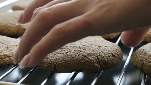 Female picks homemade cookie close-up 4K 2160p 30fps UltraHD footage - Hand picking bread produc