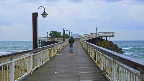 Man Walking on the Pier