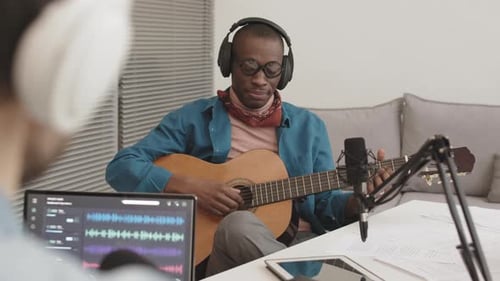 Man Plays Guitar for Recording Session