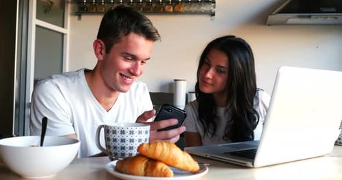 Young Adults Using Technology at the Kitchen Table