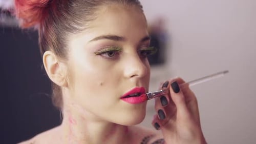 Woman Applying Lipstick with Makeup Artist