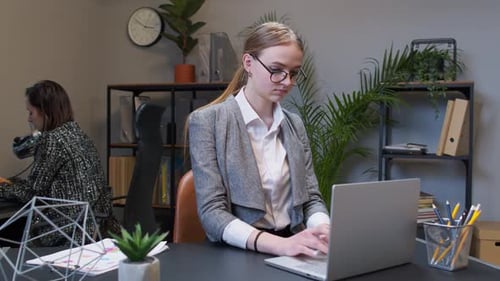 Woman Working on Laptop in Modern Office