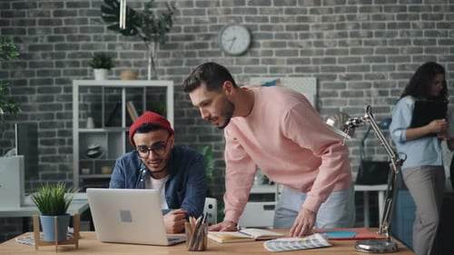 Two Young Adults Collaborating in an Office