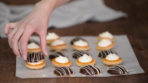 Hand Assembling Small Chocolate Striped Pastries