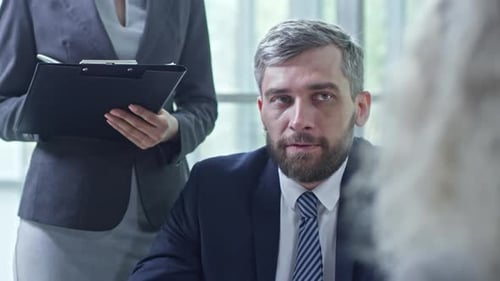 Man Discusses Business in Meeting With Colleagues