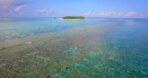 Aerial drone view of a scenic tropical island in the Maldives.