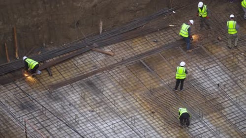 Workers Cut Rebar On Construction