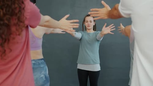 Group Warming Up Wrists and Hands in Studio