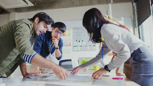 Team Collaborating on Project in Bright Office