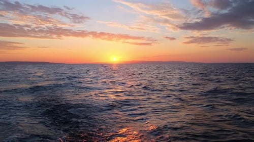 Sun Rises Over Sea Waves at Early Morning