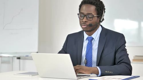 African Businessman Talking with Customer in Call Center