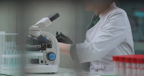 Female Technician Is Researching Analysis in Lab, Using Test Tubes with Liquids and Microscope